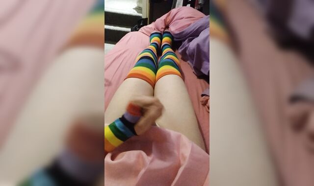 Weak femboy in pink college girl uniform and rainbow gloves & pantyhose blows a load