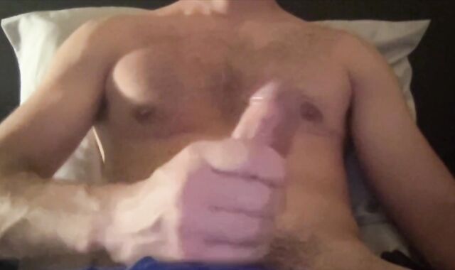 fit boy makes his gigantic pipe spunk while laying in his bed