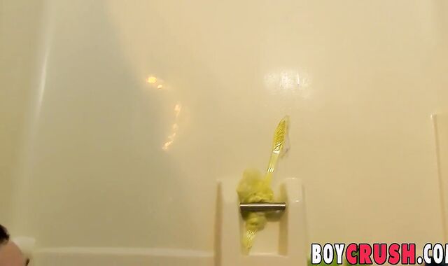 Fine looking youngster plays with his pecker in the shower solo