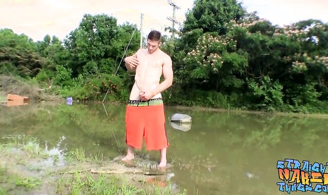 Fit boy Elijah Knight tugging off outdoors near a lake