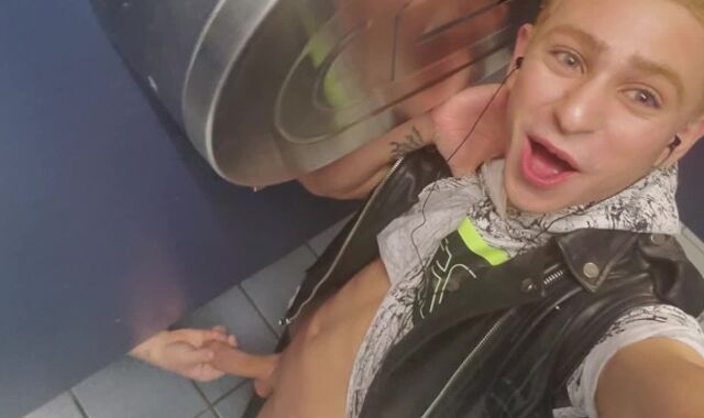 Stranger reaches under stall to grasp Daniel Hausser's trunk