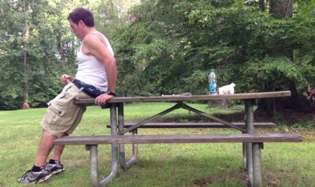 Milking in the public park next to the busy road.