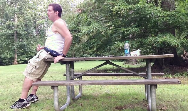 Milking in the public park next to the busy road.