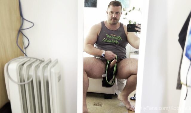 Wooly muscle teddy Koby Falks canes his humungous uncut schlong and splashes onto a pair of Bonds trunks