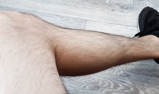 Russian boy with fur covered legs draining off his good-sized pink cigar in sneakers