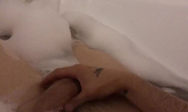 The stud milks off taking a tub with foam