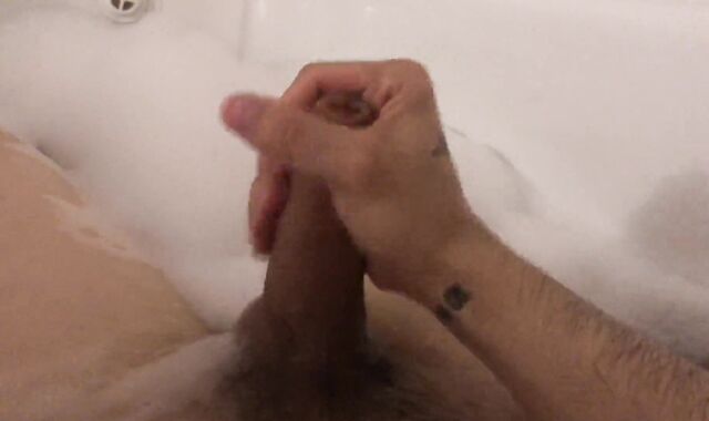 The stud milks off taking a tub with foam