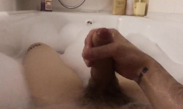 The stud milks off taking a tub with foam