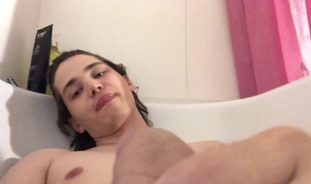 A young man is playing with his dude-meat in the bathroom