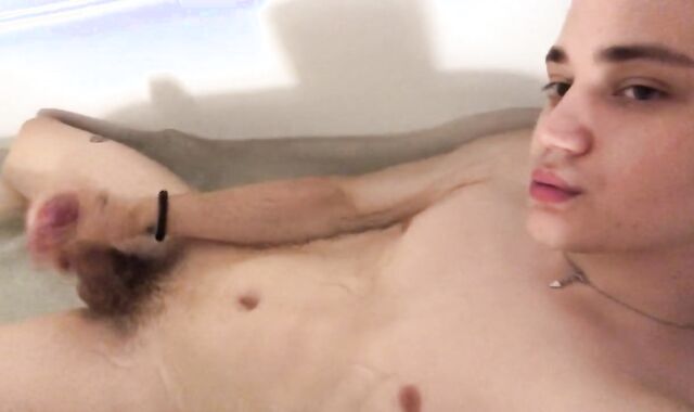 A young man is playing with his dude-meat in the bathroom