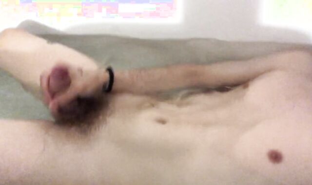 A young man is playing with his dude-meat in the bathroom