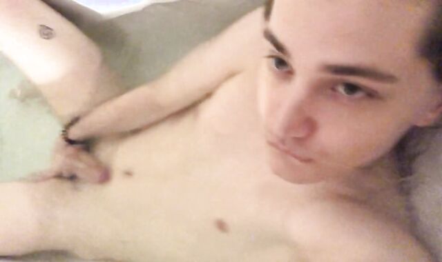 A young man is playing with his dude-meat in the bathroom