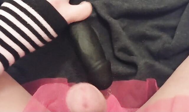 Femboy teases knob with giant dark-hued fake-lollipop and comes all over it