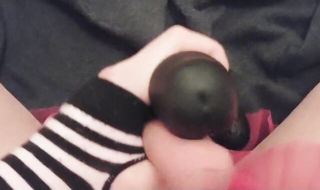 Femboy teases knob with giant dark-hued fake-lollipop and comes all over it
