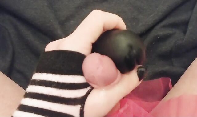 Femboy teases knob with giant dark-hued fake-lollipop and comes all over it