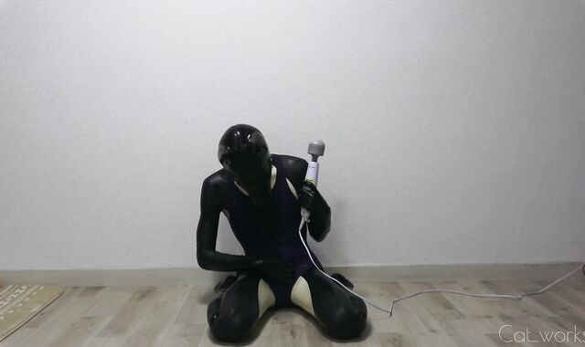 Latex dog crossdresser clothed in latex catsuit and one-chunk bathing suit