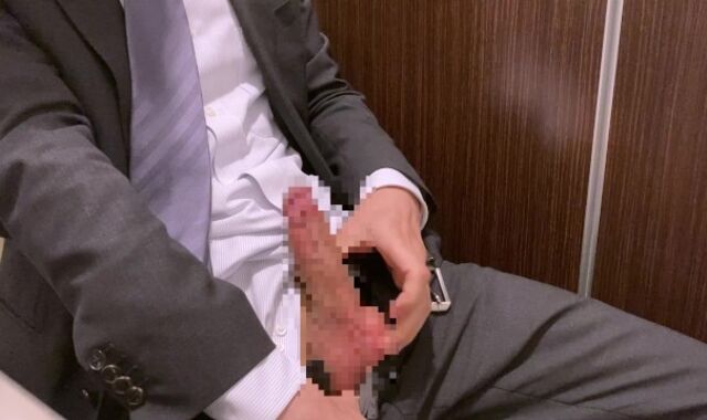 Asian man milking during work