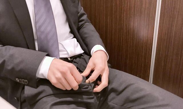 Asian man milking during work