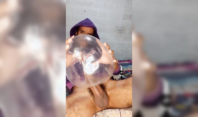 youthful guy masturbates with inflated comdon