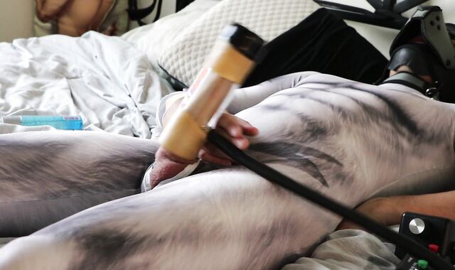 Pup clad in petsuit shoots a fountain enormous using Venus 2000 milker