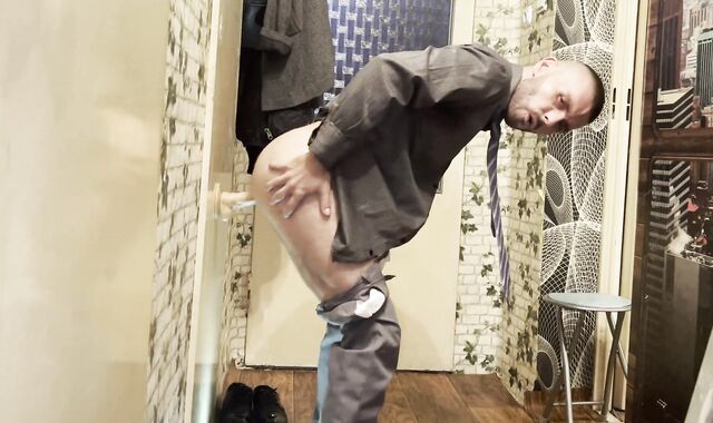 Suited dude in socks and tie with a shag stick