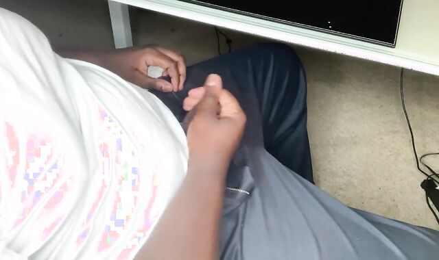 Black Fellow Milks In Office At Desk