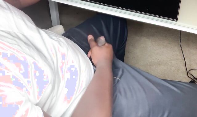 Black Fellow Milks In Office At Desk