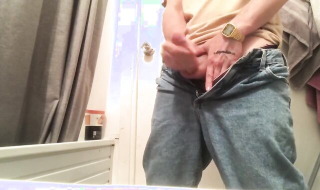 A dude in jeans drained off his boner and cummed