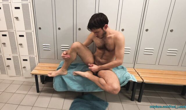 Playing with feet and dick in the locker room