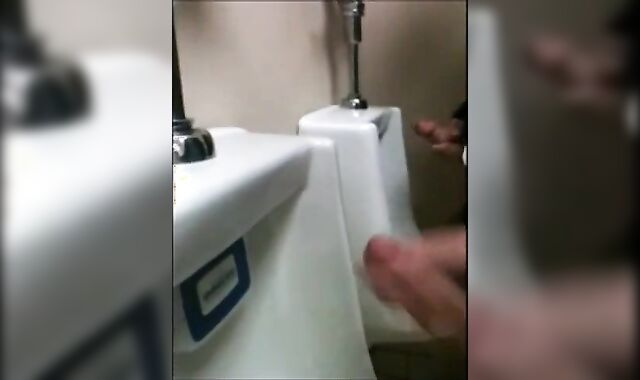 two slim dicks getting wanked at the urinals