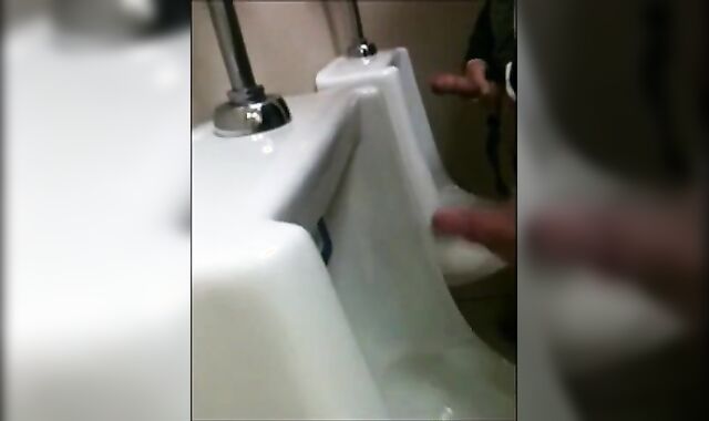 two slim dicks getting wanked at the urinals
