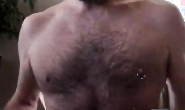 Hairy bear daddy strokes his meat