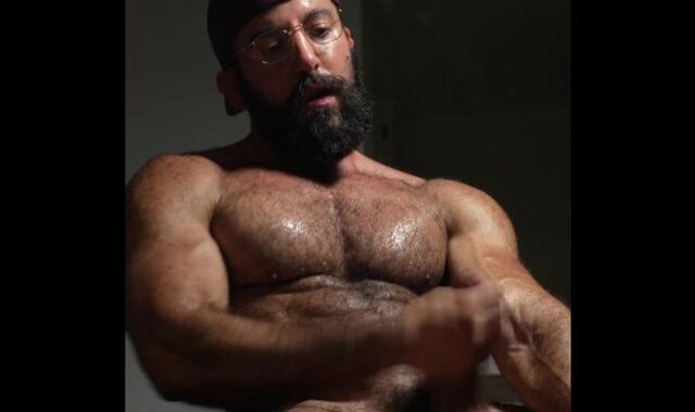 Unshaved bearded muscle boy with an uncircumcised massive stiffy