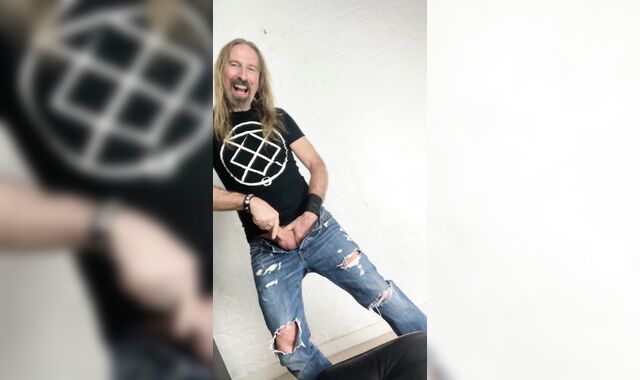 Longhairdude drains and shoots in torns denim, Fresh Rock biker shoes, tshirt