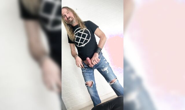 Longhairdude drains and shoots in torns denim, Fresh Rock biker shoes, tshirt