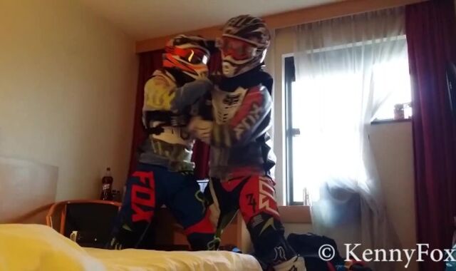 Ficht in motocross gear over who is going to be the bottom